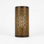 Front view of a dark curved brass wall sconce with a central arabesque medallion