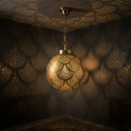 Brass globe pendant casting scalloped patterns across dark walls and ceiling