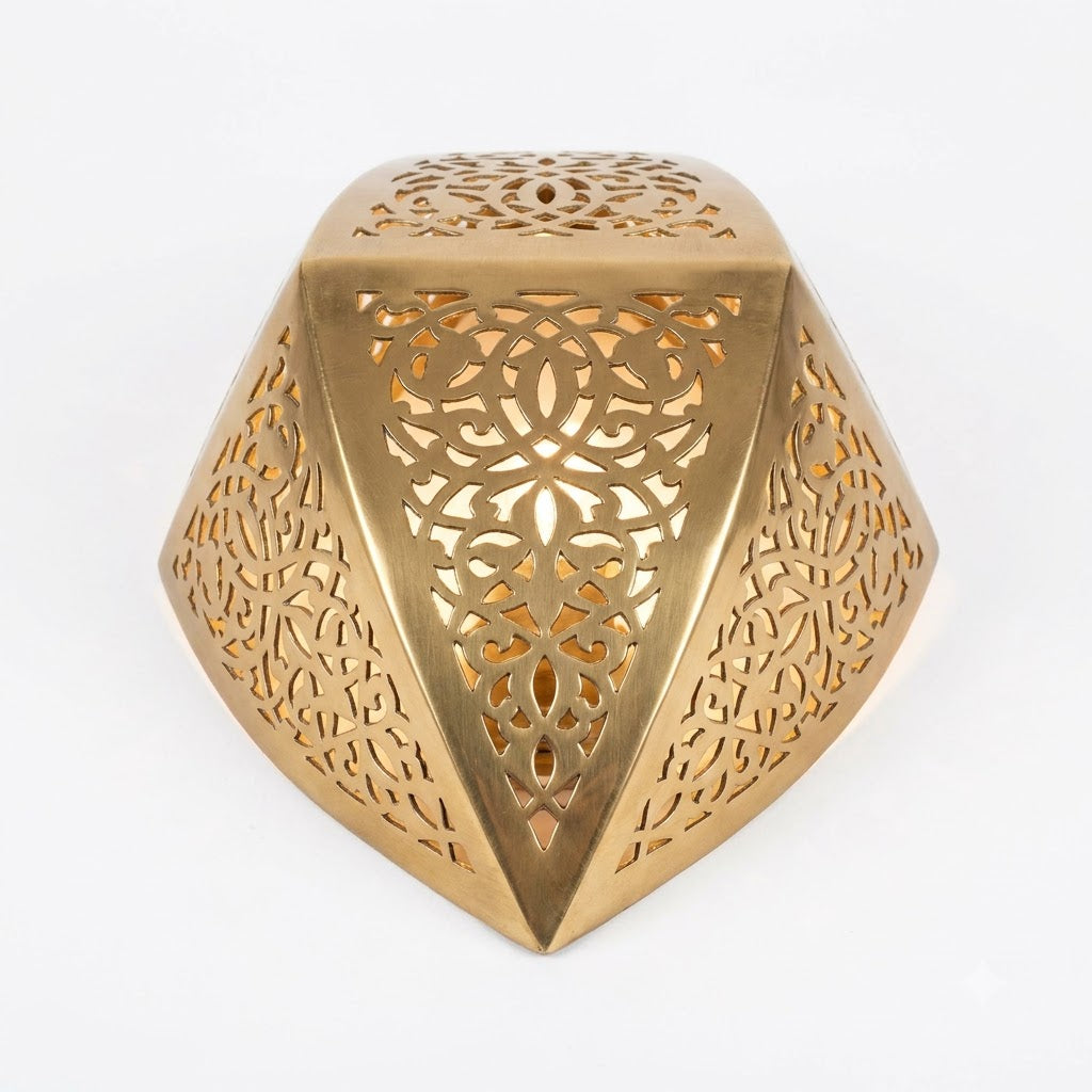Angled view of a gold-toned faceted teardrop wall sconce with an open top
