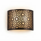 Front view of a wide curved Moroccan brass wall sconce with star lattice cutouts