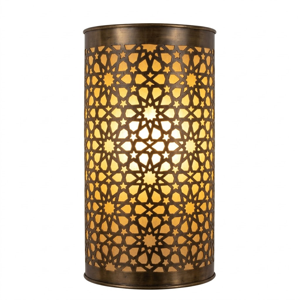 Curved dark brass wall sconce glowing through a geometric star lattice