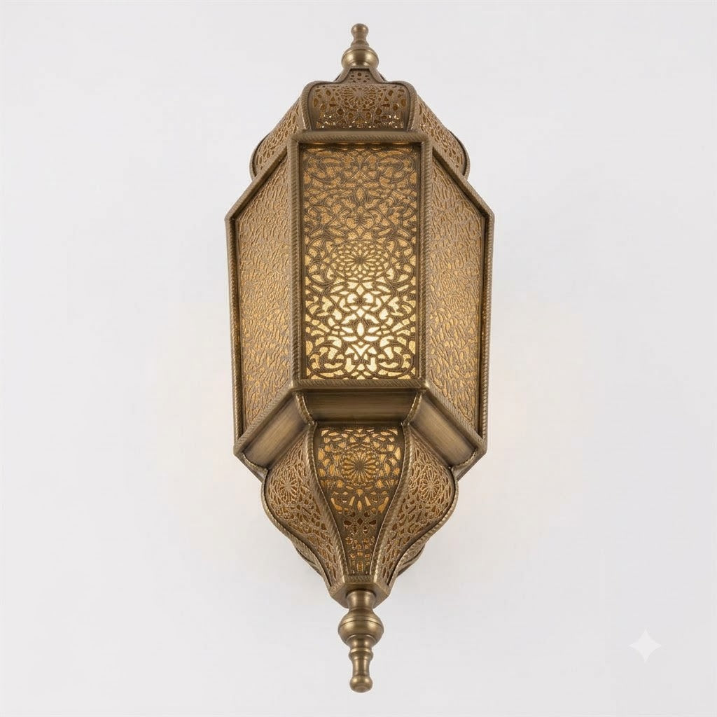 Angled view of a tall Moroccan brass wall lantern with faceted panels and a pointed finial