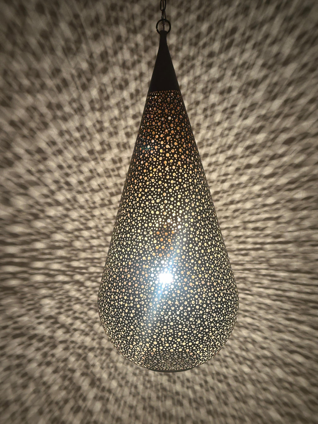 Moroccan Perforated Teardrop Pendant with a perforated brass teardrop silhouette