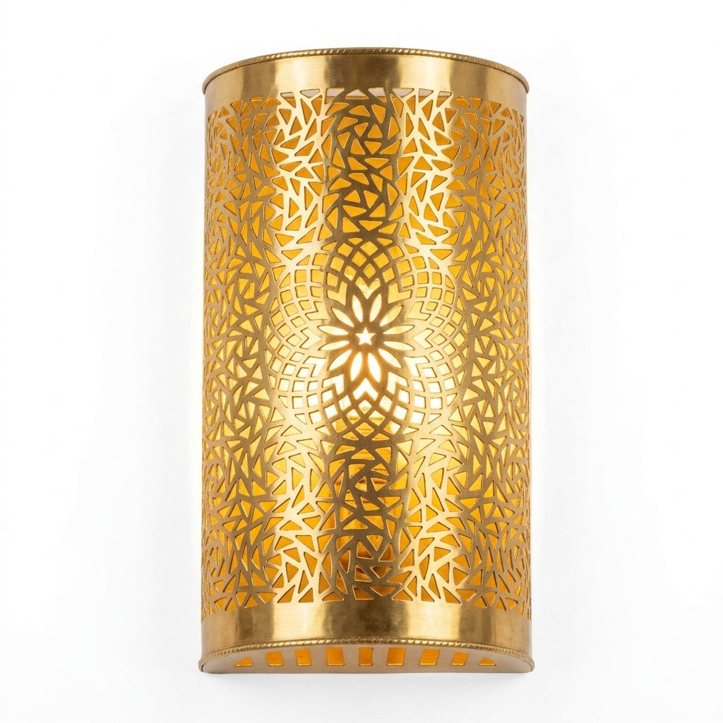 Illuminated curved brass wall sconce with a pierced floral rosette pattern