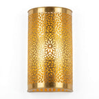 Illuminated curved brass wall sconce with a pierced floral rosette pattern